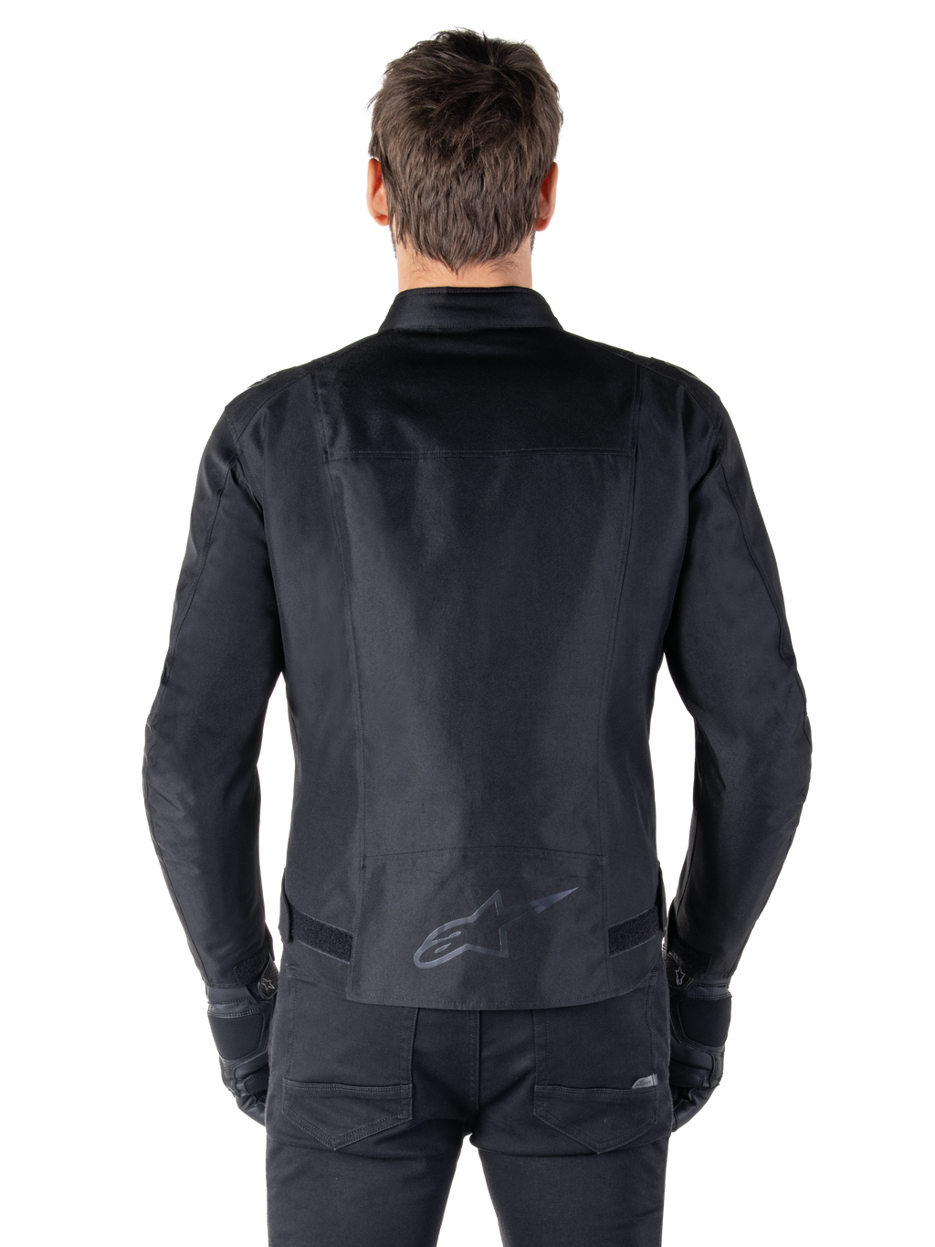 Alpinestars T-SPS V2 Waterproof Jacket, Black, back view showing the sport cut silhouette, reflective Alpinestars logo on the lower back, and extended back for extra coverage while riding.