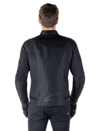 Alpinestars T-SPS V2 Waterproof Jacket, Black, back view showing the sport cut silhouette, reflective Alpinestars logo on the lower back, and extended back for extra coverage while riding.