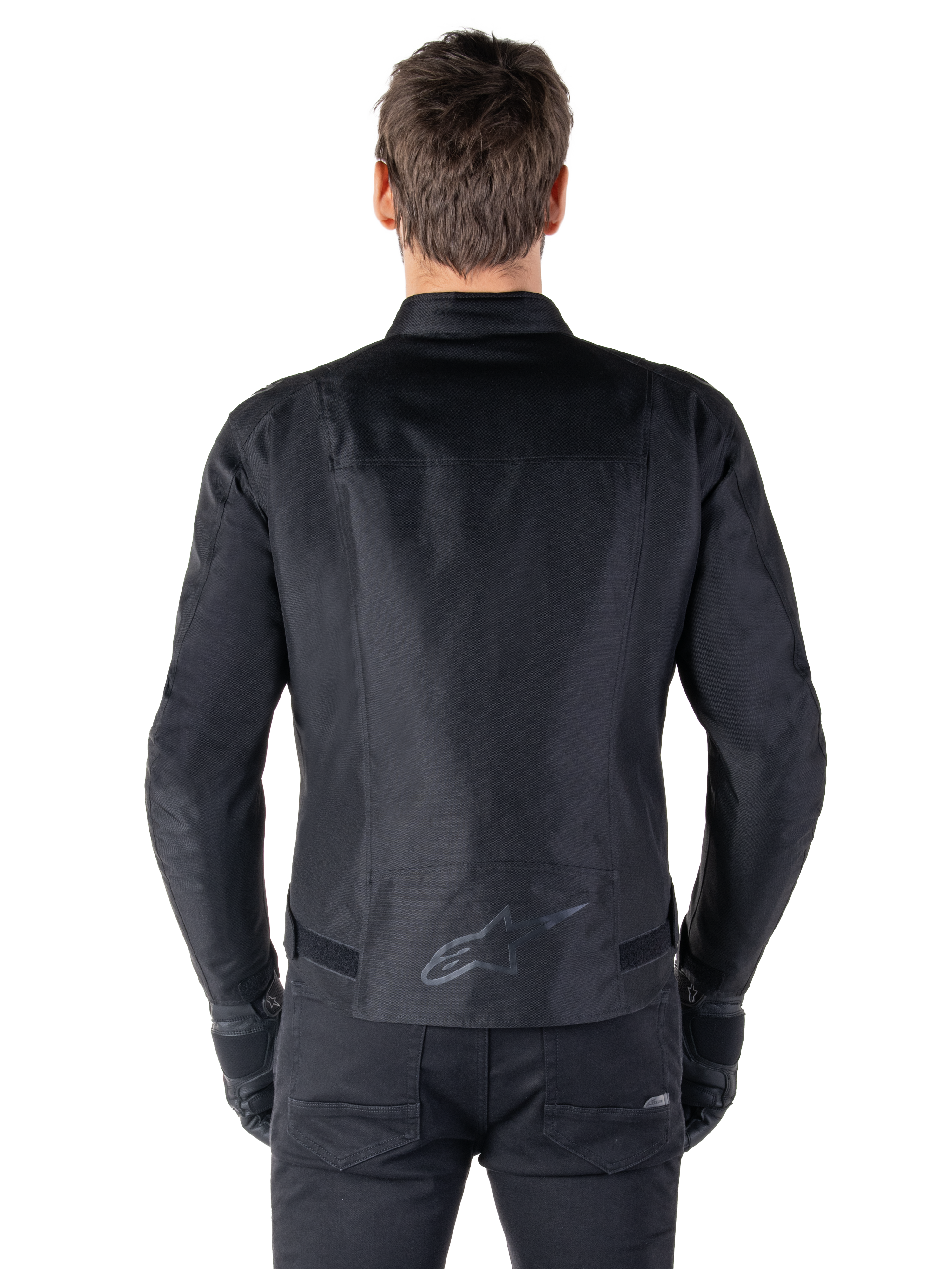 Alpinestars T-SPS V2 Waterproof Jacket, Black, back view showing the sport cut silhouette, reflective Alpinestars logo on the lower back, and extended back for extra coverage while riding.