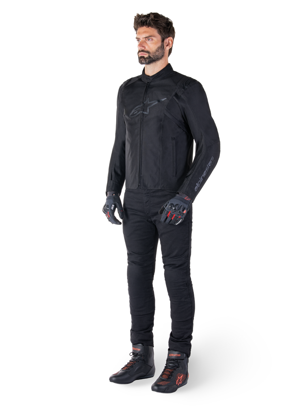 Alpinestars T-SPS V2 Waterproof Jacket, Black, worn by a male model with matching black pants, black gloves with red accents, and black riding shoes, full motorcycle gear for urban and sport riding, clean white background