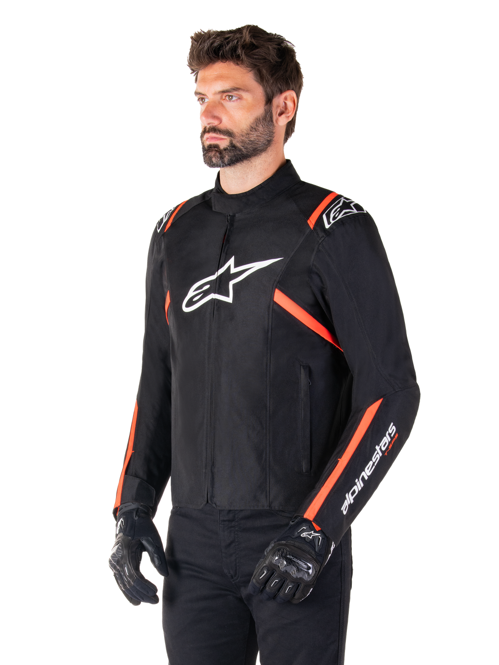 Alpinestars T-SPS V2 Waterproof Jacket, Black White and Red Fluo, worn by a male model with black gloves and pants, featuring a white Alpinestars logo on the chest and fluorescent red accents on the shoulders and sleeves, sporty textile design