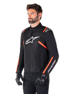 Alpinestars T-SPS V2 Waterproof Jacket, Black White and Red Fluo, worn by a male model with black gloves and pants, featuring a white Alpinestars logo on the chest and fluorescent red accents on the shoulders and sleeves, sporty textile design