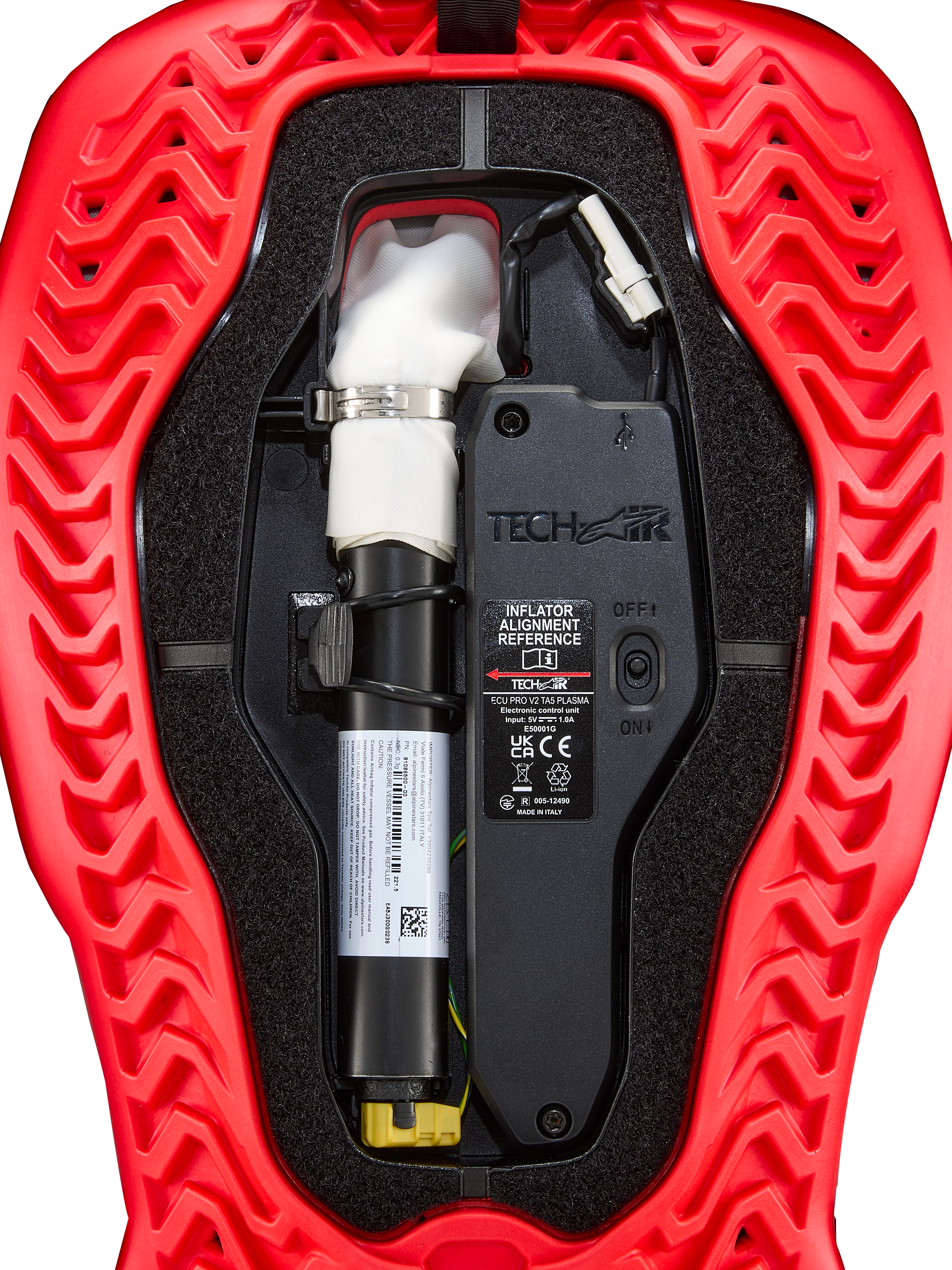 Alpinestars Tech-Air® 5 Plasma Airbag Replacement Canister, Airbag System Accessory, red and black, close-up internal view showing the white argon inflator canister with silver clamp, electronic control unit with ON/OFF switch, and wavy ribbed red outer shell