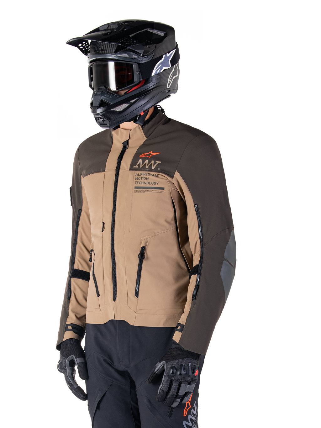 Alpinestars AMT-8 Stretch Drystar® XF Jacket, Adventure Motorcycle Jacket, Dark Brown and Dark Khaki, worn with a black off-road helmet and goggles, featuring Alpinestars Motion Technology branding and zippered ventilation ports.