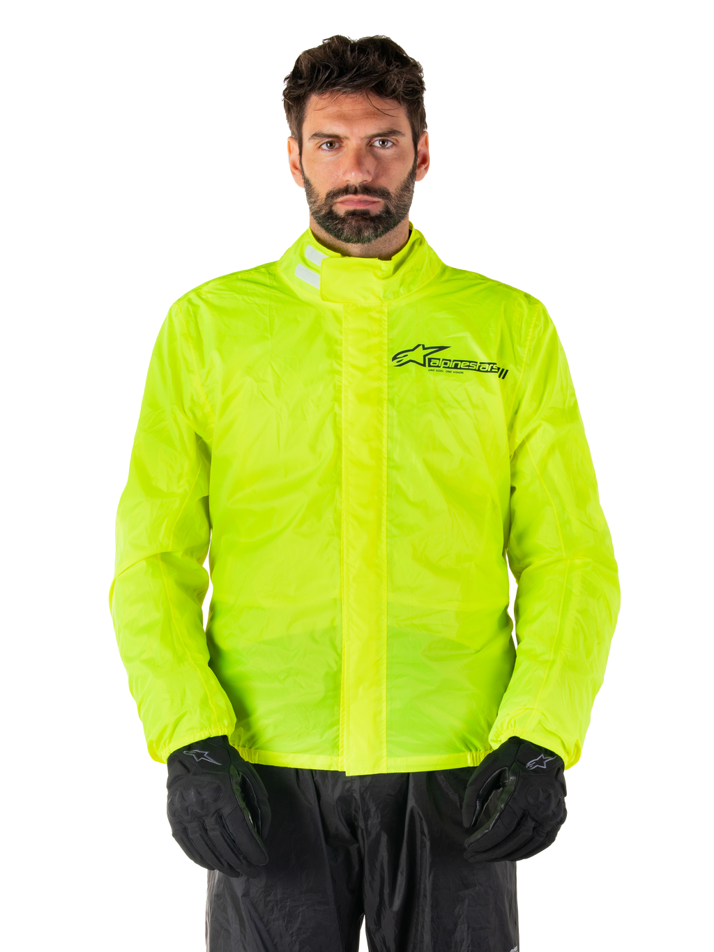 Alpinestars Hurricane Rain V2 Jacket, Motorcycle Rain Jacket, Yellow Fluo, worn by a model with black pants and gloves, high collar with reflective tabs, front storm flap with Alpinestars logo, high-visibility waterproof gear