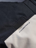 Alpinestars Andes V4 Drystar® Jacket, close-up detail of the hydration hose loop on the chest, Walnut Mastic and Black colorway, durable textile fabric with 'HYDRATION' printed label, practical feature for adventure motorcycle riding