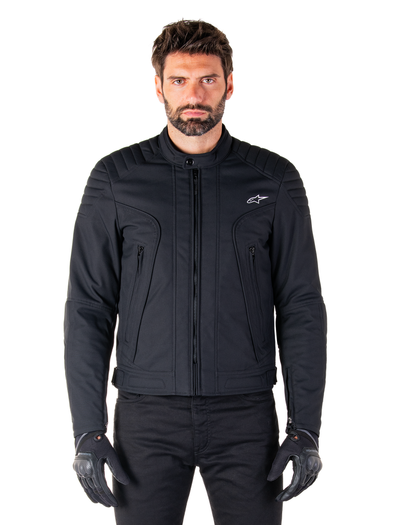 Alpinestars Clayton WR Jacket, Black Motorcycle Jacket, worn by model, featuring quilted shoulder details and technical graphics, central Vislon zipper, vertical zippered pockets, small white logo on chest, urban riding gear for road use