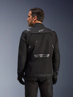 Rear view of the black Alpinestars Cusco Drystar® Jacket for men, featuring a large storage pocket and reflective branding.