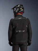 Alpinestars Cusco Drystar® Jacket, Black, Back view of a rider wearing a black helmet and gloves, features large ventilation panels, white logo on the neck and reflective branding on the lower back, adventure touring gear