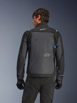 Alpinestars Cusco Drystar® Jacket, Motorcycle Jacket, Black and Deep Gray, back view on a model showing large gray rear panel, white Alpinestars logo, and blue accents on sleeves.