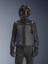 Alpinestars Cusco Drystar® Jacket, Black and Deep Gray, motorcycle adventure touring jacket worn with matching black technical pants and a dual-sport helmet, featuring a two-tone design with ripstop panels and Alpinestars branding
