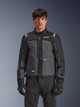 Alpinestars Cusco Drystar® Jacket, Motorcycle Touring Jacket, Black and Deep Gray, front view on model, featuring Alpinestars logos on chest and shoulders, Drystar® sleeve branding, technical multi-pocket design with ventilation zippers, paired with black riding gear