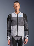 Alpinestars ST-2 Air Jacket, Men's Motorcycle Jacket, Ice Gray and Dark Gray with Black accents, wide mesh ventilation panels, laser-perforated front, blue Alpinestars logo, front zipper, worn by a model with matching riding pants