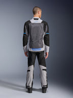 Alpinestars ST-2 Air Jacket, Ice Gray Dark Gray Black, rear view on model, featuring large mesh ventilation panels, blue accents and Alpinestars logo, paired with matching motorcycle pants for adventure touring.