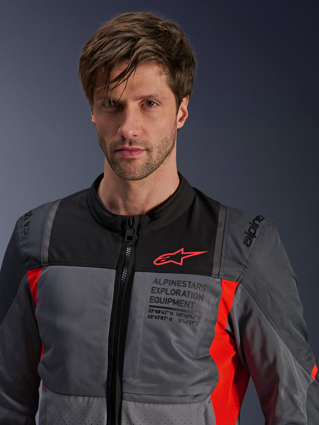 Alpinestars ST-2 Air Jacket, Men's Gray and Red Textile Touring Jacket with mesh ventilation, worn by a model.