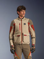 Alpinestars Maxdura Drystar®XF Laminated Armored Shell, Aluminum Walnut Rust Brown, Adventure motorcycle jacket worn by a male model, featuring large front cargo pockets and technical red accents, paired with matching adventure riding pants and gloves