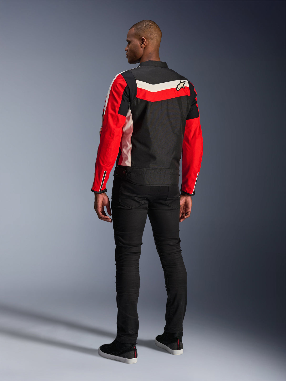 Alpinestars T-Dyno WR Jacket, Textile Motorcycle Jacket, Black Bright Red and Ecru, back view on model, vintage-inspired biker fit with heritage color panels and logo, modern urban road gear.