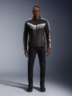 Alpinestars T-Dyno WR Jacket, Black Dark Gray and Ecru, textile motorcycle jacket with vintage-inspired chevron chest pattern, worn by male model with black riding pants and boots, urban contemporary road gear