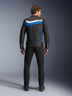 Alpinestars T-Dyno WR Jacket, textile motorcycle jacket, Black Blue Ecru colorway, full back view on model, featuring a blue and off-white chevron stripe with Alpinestars logo, paired with black pants and boots, vintage-inspired urban riding gear