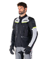 Alpinestars Bogotá Pro Drystar® Jacket, Black and Ice Gray adventure touring jacket with Yellow Fluo accents, worn by a man.