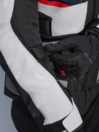 Alpinestars Andes Air Drystar® Jacket in Deep Blue Black Ice Gray, close-up view of the adjustable sleeve strap and mesh ventilation panels, featuring durable textile construction for adventure touring