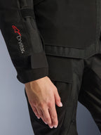 Alpinestars Woman Stella Andes V4 Drystar® Jacket, close-up of the sleeve featuring the red Drystar® logo and adjustable cuff, black textile material, adventure-touring motorcycle apparel