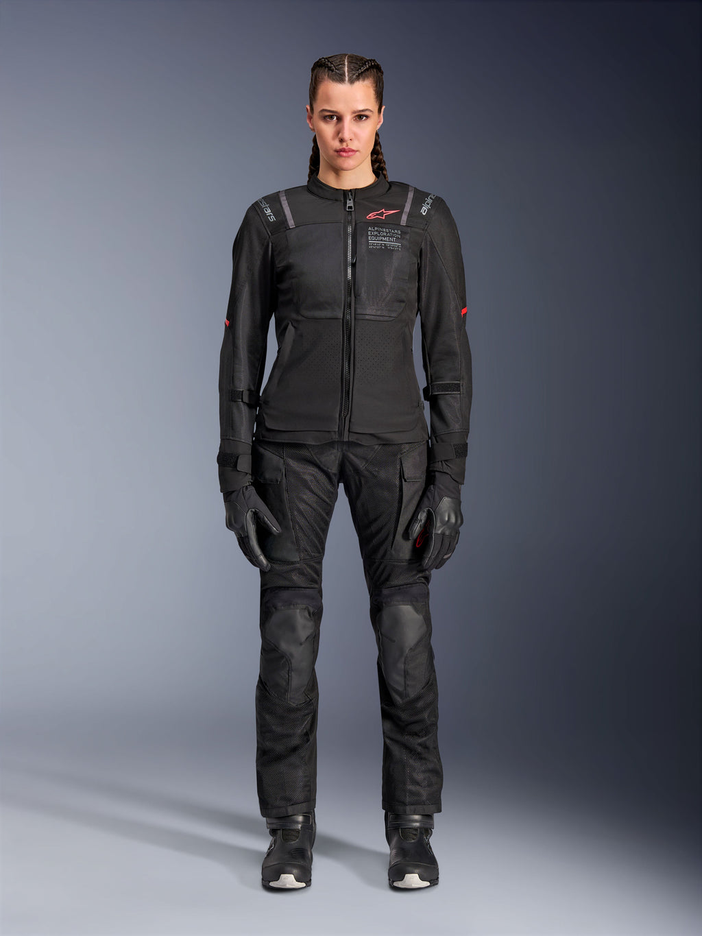 Alpinestars Stella Andes Air Drystar Pants, Women's Motorcycle Touring Pants, Black, featuring mesh ventilation panels and reinforced knee protection, worn with matching jacket and gloves, adventure touring apparel