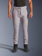 Alpinestars Aeroshell Pants, Mid Gray and Yellow Fluo, crossover softshell motorcycle pants, featuring a black drawstring waist and fitted ankle cuffs, yellow logo on left thigh, pre-curved knees, sporty jogger-style silhouette