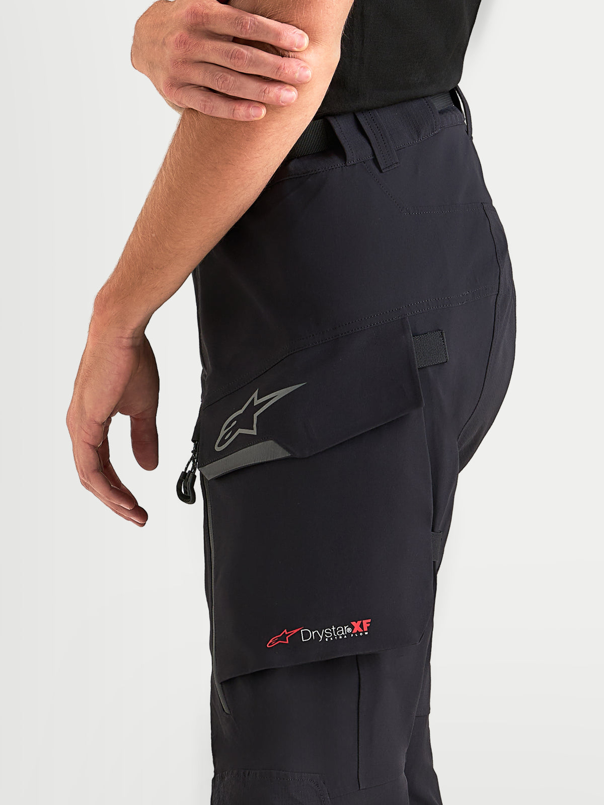 Alpinestars Maxdura Drystar XF Laminated Pants, Men's Adventure Motorcycle Pants in Black and Dark Gray, featuring a water-resistant cargo pocket with a reflective Astar logo and Drystar XF branding