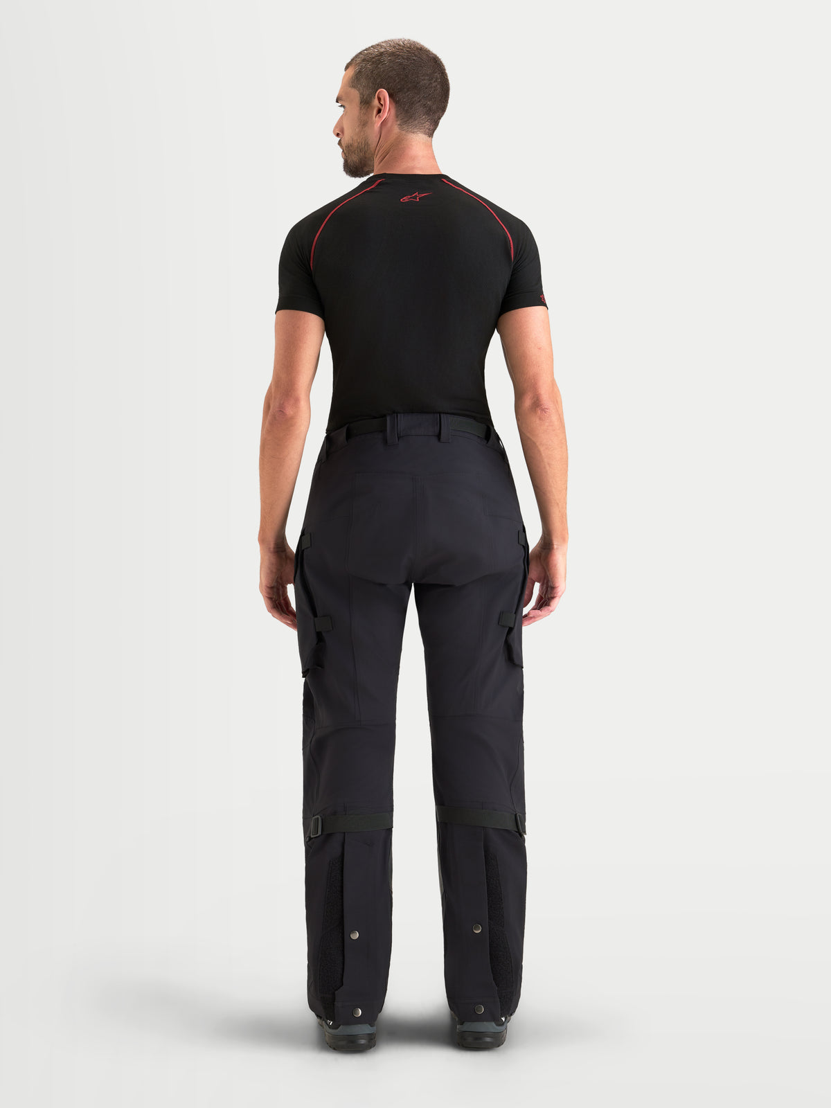 Alpinestars Maxdura Drystar XF Laminated Pants, Men's Adventure Motorcycle Pants, Black and Dark Gray, waterproof textile riding pants with rear view showing cargo pockets and adjustable lower legs