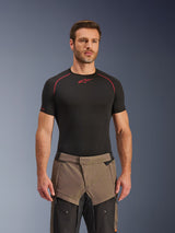 Alpinestars Cusco Drystar® Pants, Walnut Black adventure motorcycle pants, worn by a model with a black Alpinestars base layer shirt, featuring a two-tone brown and black textile design with reinforced panels for touring.