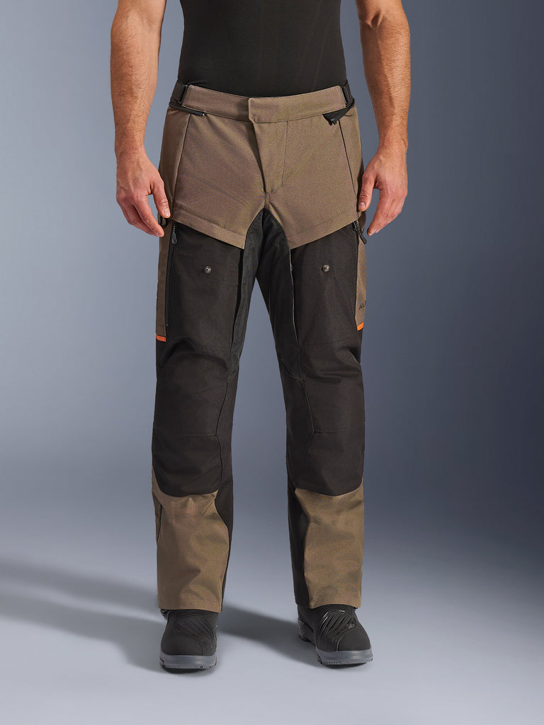 Alpinestars Cusco Drystar® Pants, Adventure Touring Motorcycle Pants, Walnut and Black with orange accents, front view on model, featuring technical textile construction, cargo pockets, and ventilation zippers, worn with black riding boots