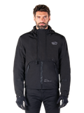 Alpinestars Mootant Waterproof Parka, Black hooded motorcycle jacket with a modular technical design, worn by a male model with black gloves, featuring a unique chest flap and zippered side pockets, urban and touring riding style.