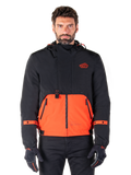 Alpinestars Mootant Waterproof Parka, modular motorcycle jacket in Spicy Orange and Black, worn by a model with matching gloves, features a hooded design with two-tone panels, front zipper, and adjustable cuffs, urban contemporary riding apparel
