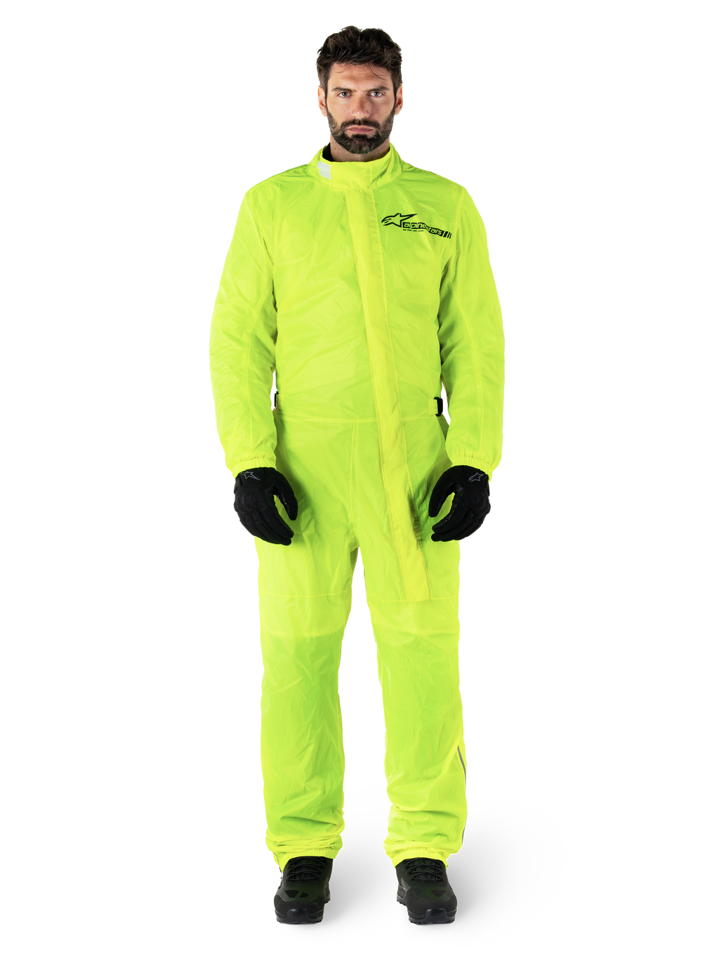 Alpinestars Hurricane Rain V2 Suit, Motorcycle Rain Suit, Yellow Fluo, male model wearing full-body protection with black gloves and boots, high collar with front storm flap, reflective logo on chest, high-visibility waterproof gear