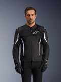 Alpinestars AST V3 Air Jacket, Motorcycle Jacket, Black Dark Gray and White, worn by a man with matching black gloves, featuring technical mesh panels for airflow and sport-fit construction for warm-weather riding