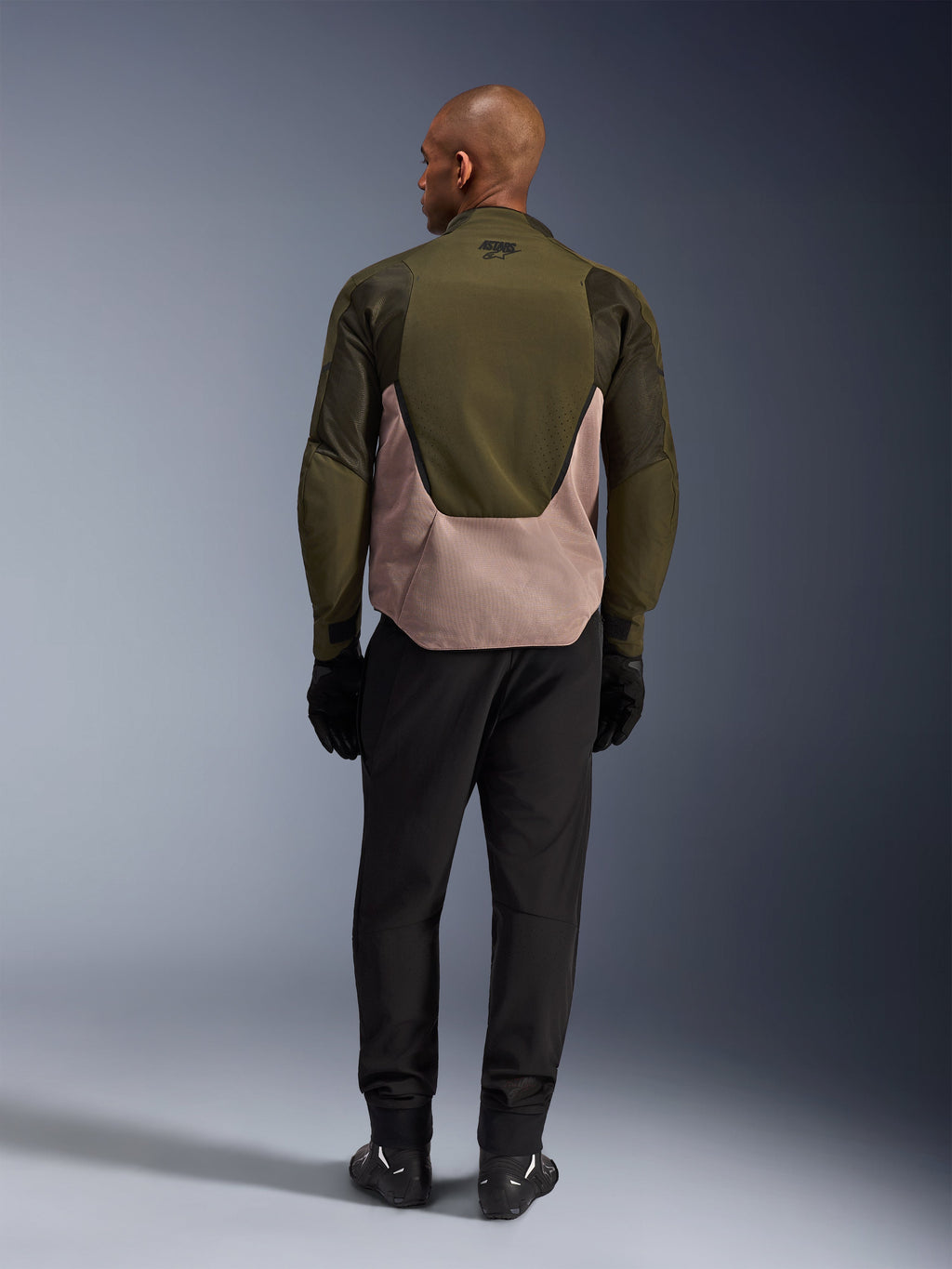 Alpinestars Aeroshell Airflow Jacket in Forest Sand, rear view on rider featuring breathable mesh and laser perforations.