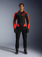 Male model wearing the Alpinestars Viper Air V4 Jacket in Red Fluo and Black, paired with black riding pants, gloves, and boots, featuring breathable mesh panels for ventilation and a bold star logo on the chest, sporty motorcycle road apparel