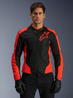 Alpinestars Viper Air V4 Jacket, Motorcycle Racing Jacket, Red Fluo and Black, worn by model with black gloves, tech mesh panels for ventilation, sporty design with Alpinestars star logo on the chest