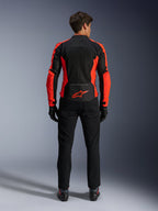 Alpinestars Viper Air V4 Jacket, Red Fluo and Black, back view showing large tech mesh panels and bright red fluorescent side accents, red Alpinestars logo on the lower back, worn with black riding pants and gloves.