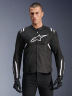 Alpinestars T-SPS Air V2 Jacket, Textile Motorcycle Jacket, Black with White Accents, large white chest logo, perforated mesh design for ventilation, worn with black pants and gloves