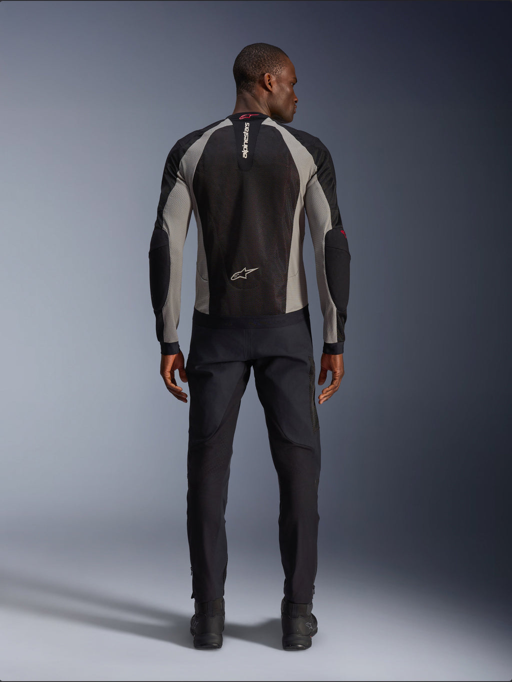 Alpinestars Troop-Air Jacket, Black Ash Gray and Bright Red motorcycle jacket, rear view on male model, lightweight mesh construction for ventilation, Alpinestars branding on collar and lower back, paired with black riding pants