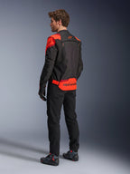Man wearing Alpinestars T-Stunt Air Jacket from the back, Black Red Fluo and Dark Red, textile motorcycle jacket with mesh panels and sport-cut design, featuring bold Alpinestars branding on the lower back, styled with black pants and riding boots