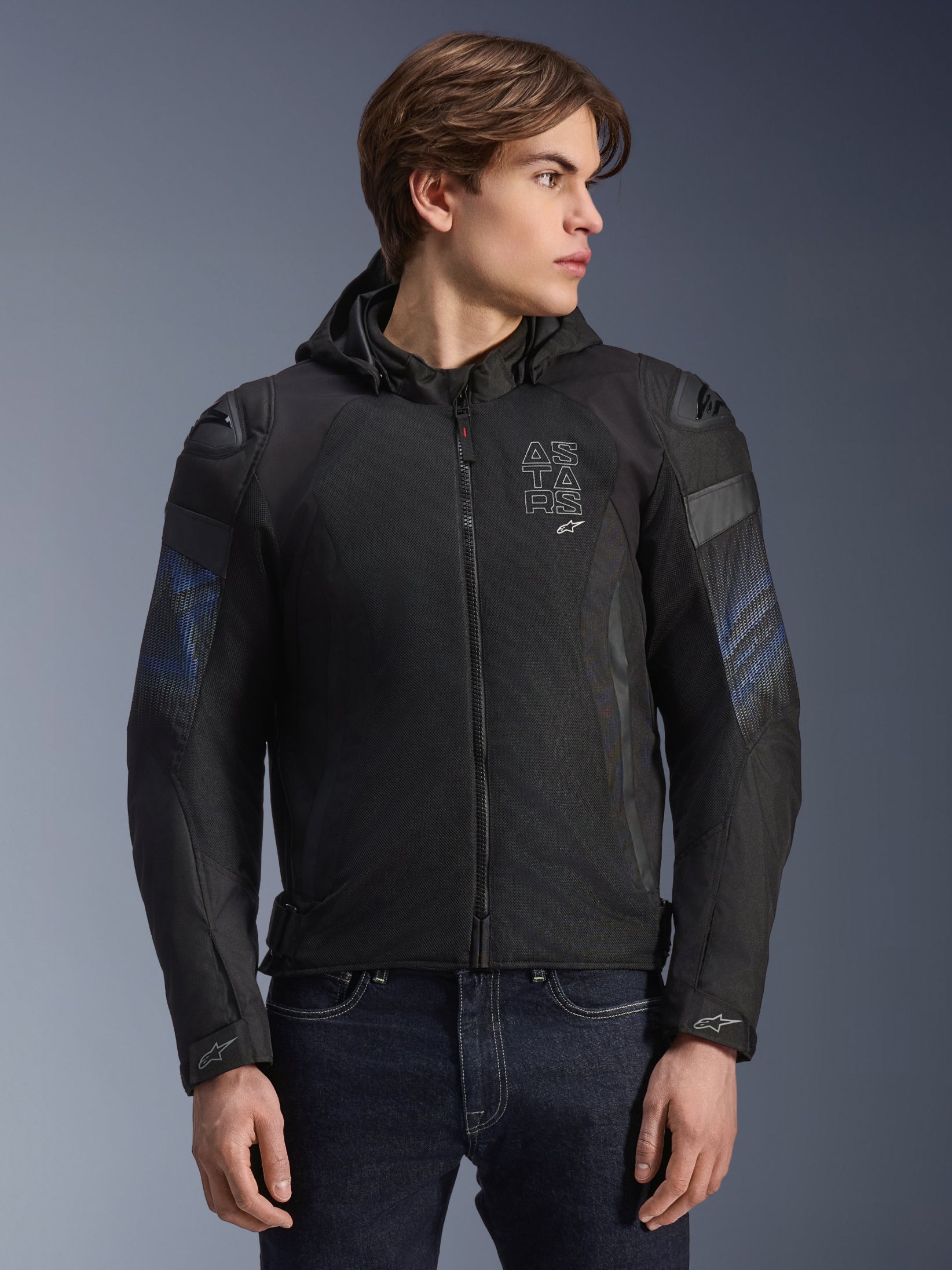 Alpinestars Zaca Air Venom WP Jacket, Black and Electric Blue, textile motorcycle jacket with a detachable hood and 3D mesh panels for ventilation, features DFS Lite shoulder sliders and ASTARS branding on the chest, worn by a male model, sport-inspired urban riding gear