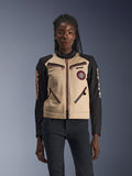 Alpinestars Stella Grace Jacket, Women's Motorcycle Jacket, Aluminum and Black, featuring a workwear-inspired design with pinkish-red zipper accents, a spiral chest patch, and long black sleeves with yellow and red graphics, worn by a model.
