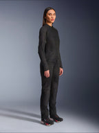Alpinestars Woman Stella C-1 Air Jacket in Black, textile motorcycle jacket with mesh panels, worn with matching black riding pants and technical sneakers, studio shot showing a full-length urban riding outfit.