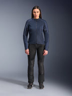 Woman model wearing Alpinestars Stella C-1 Air Jacket in Blue, urban motorcycle jacket with tech mesh panels, paired with black riding pants and black sneakers, studio front view