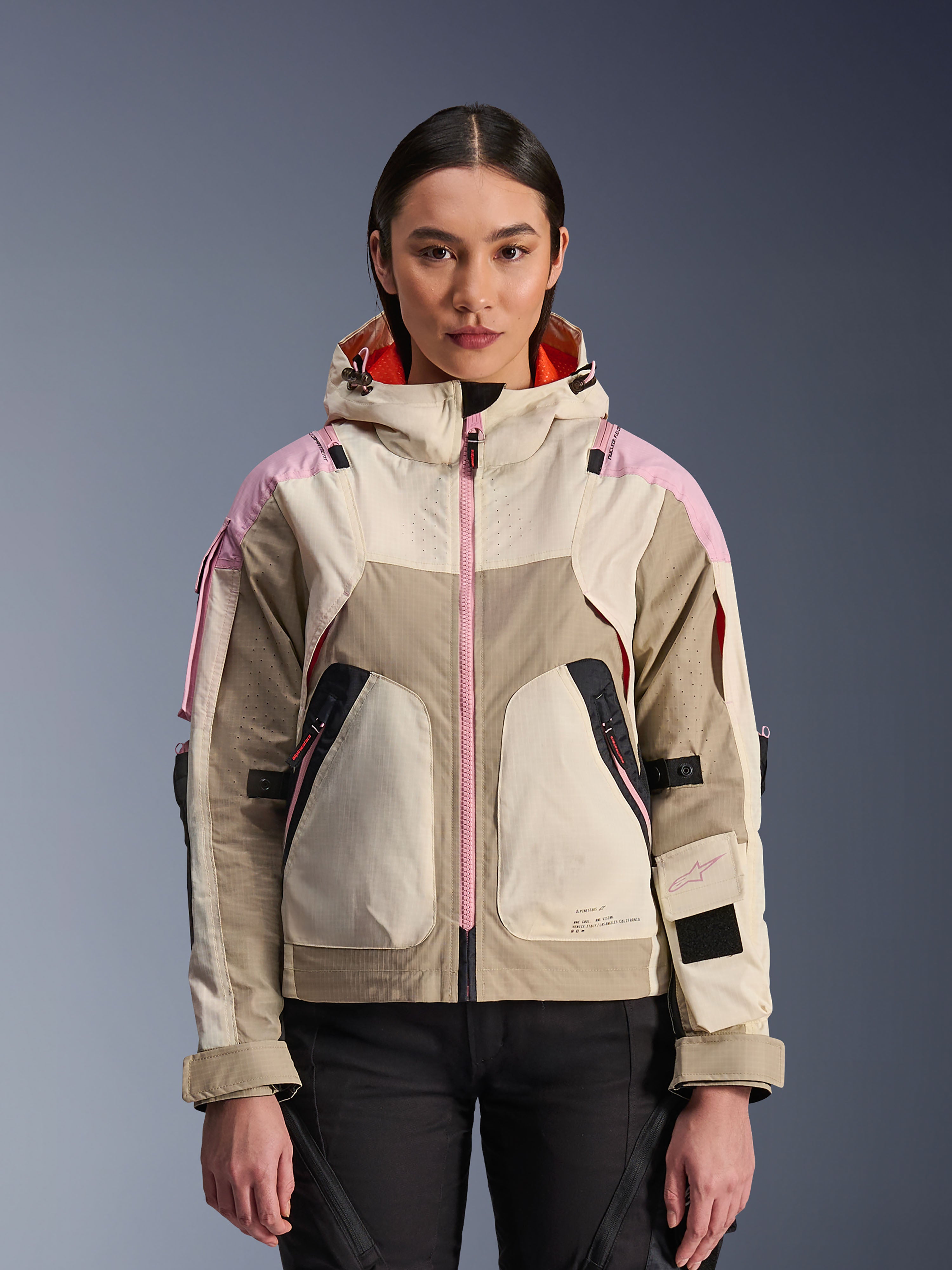 Alpinestars Molly Air Jacket, Women's Urban Motorcycle Jacket, Sand Pink Almond colorway, featuring a hooded design with laser-perforated ventilation, pink zipper detail, and adjustable sleeve straps, shown on a model.