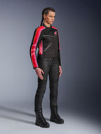 Alpinestars Stella T-Dyno Air Jacket, Women's Motorcycle Jacket, Black with Bright Red and Fuchsia stripes on sleeves, worn with black riding pants and boots, vintage-inspired mesh design for urban riding