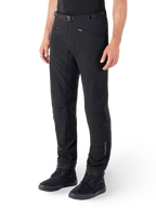 Alpinestars Alden Pants, Urban Motorcycle Pants, Black, technical softshell fabric with regular fit, featuring magnetic waist buckle, quilted side panels, zippered pockets, and subtle branding on the lower leg, worn with black riding shoes